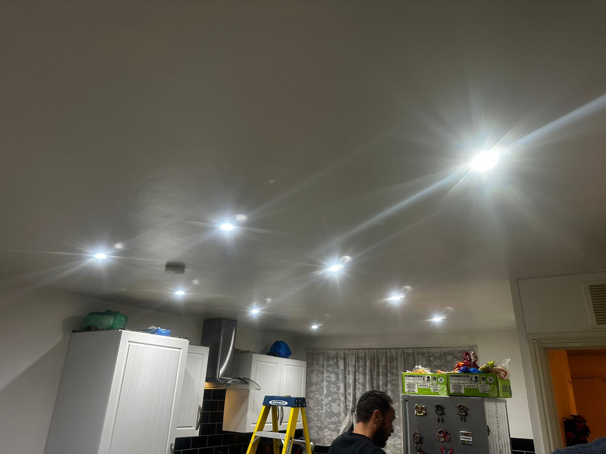 Recessed downlights being installed in kitchen or living room ceiling