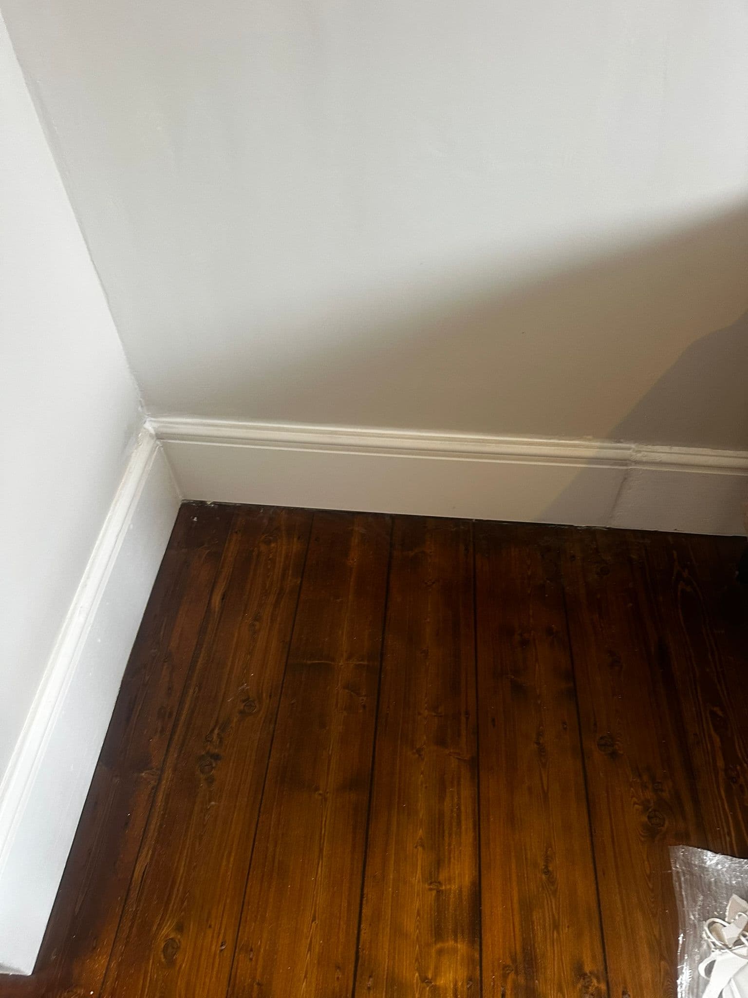 Black kitchen with integrated oven and induction hob with marble worktop