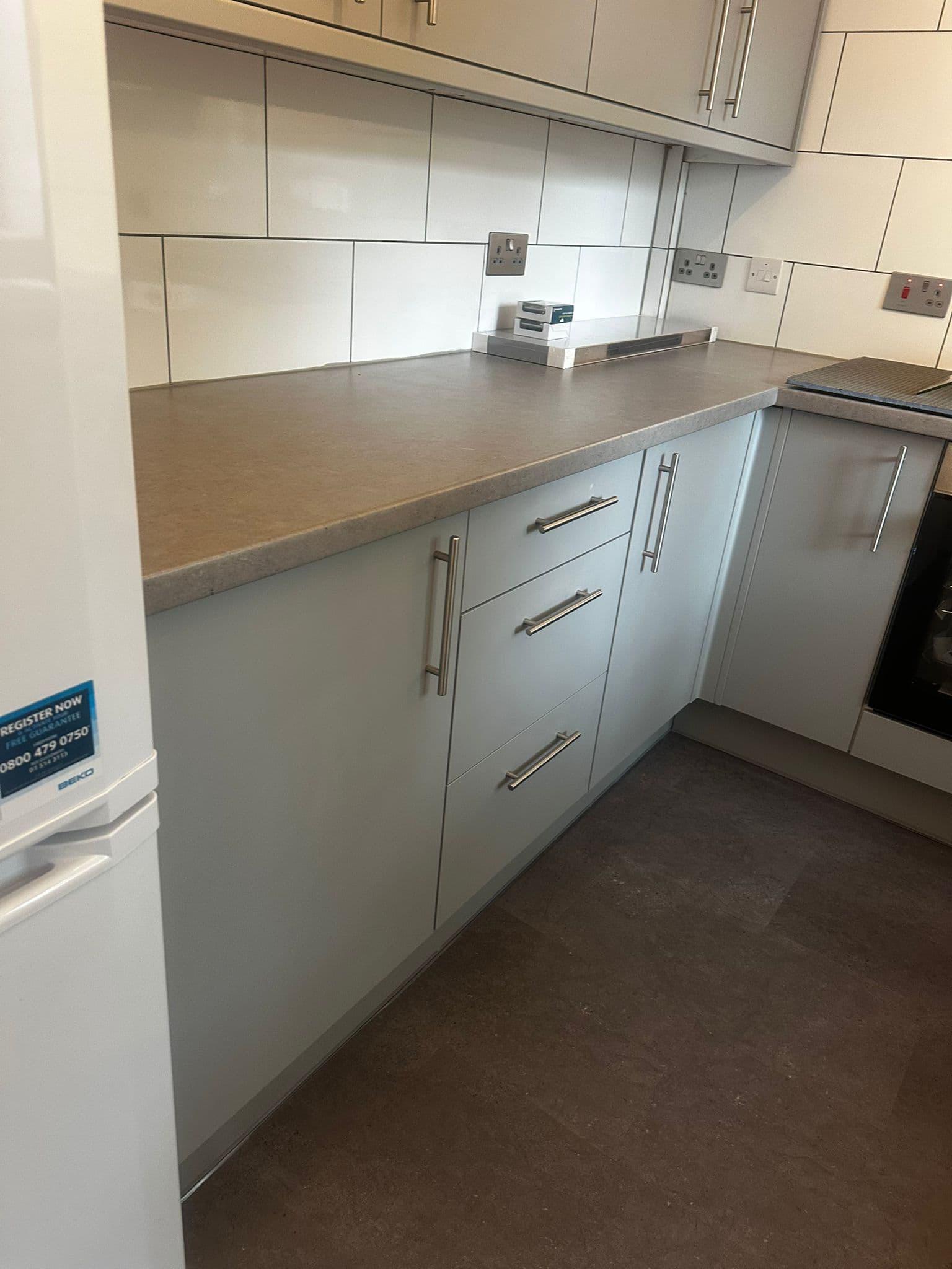 Modern kitchen with glass panel finishes and contemporary fixtures