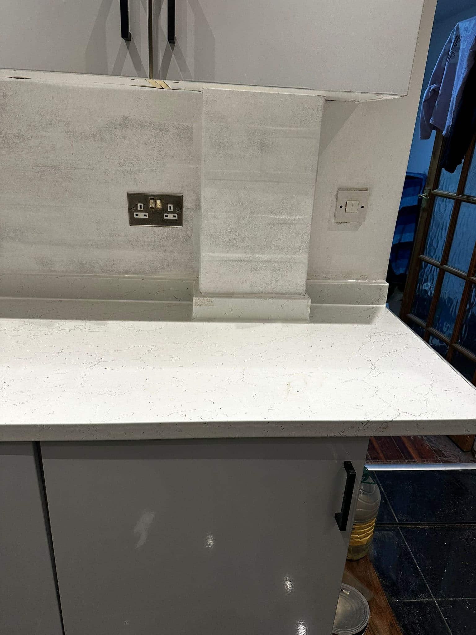 Completed kitchen sink and tap installation with tiled splashback