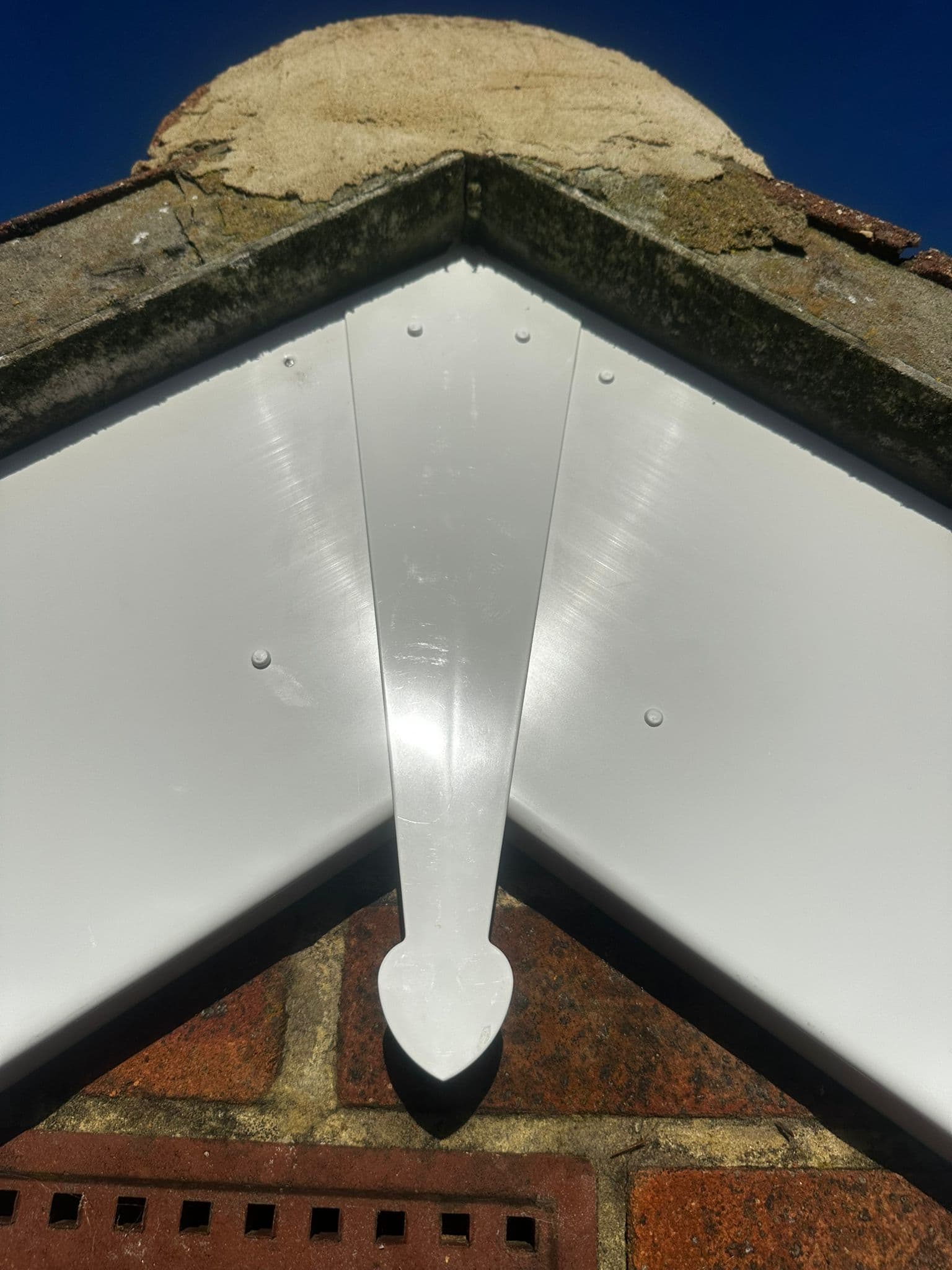 New white UPVC fascia boards installed at roof apex and gable peak